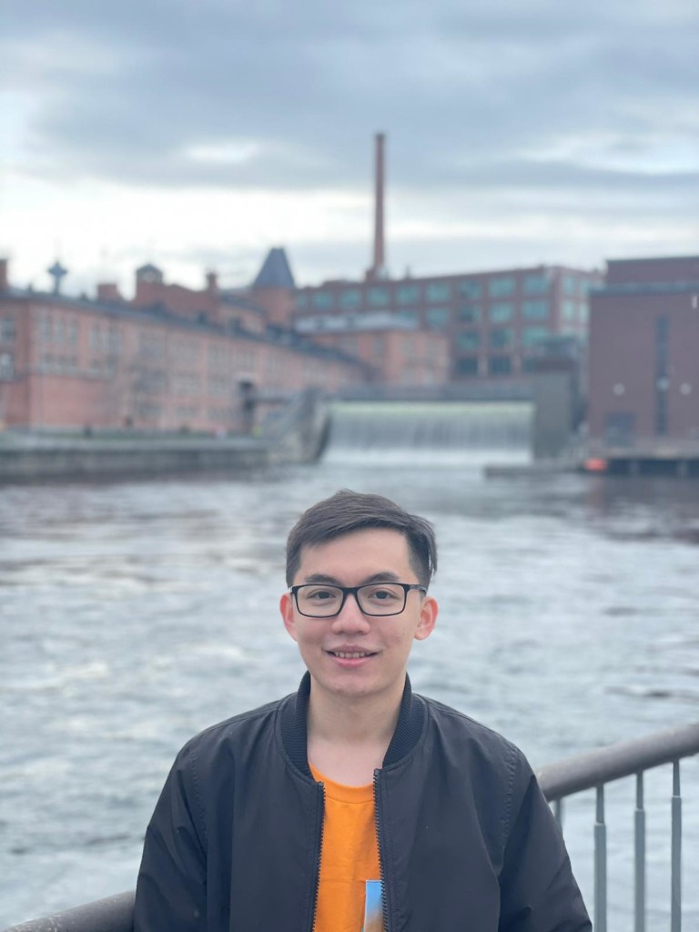 Thinh Nguyen standing outside, with Tammerkoski view on the background.