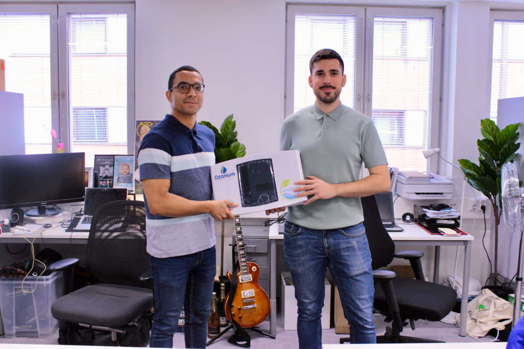 Founders of Ozonium at their office, holding the company's product in their hands.
