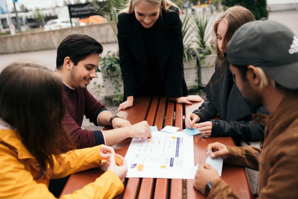 A team of students working outside around a table