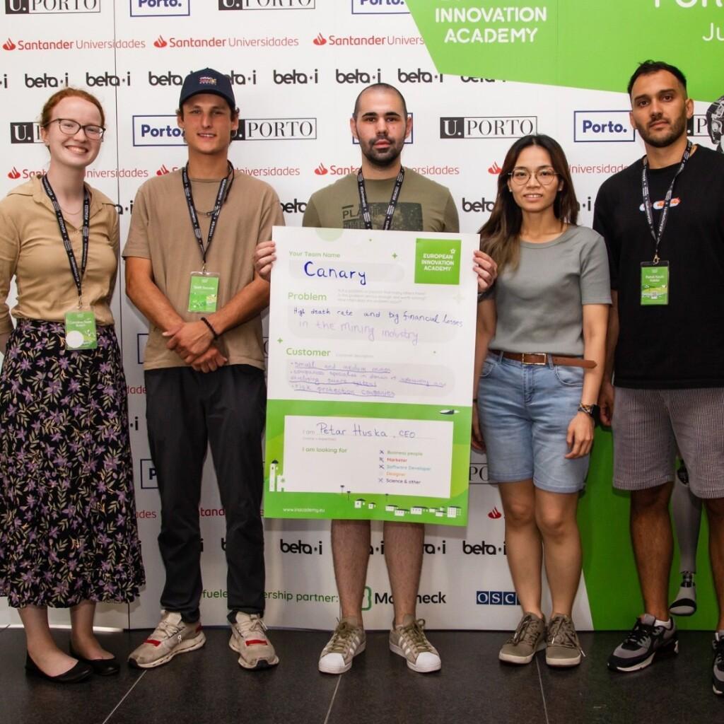 The team holding a sign.