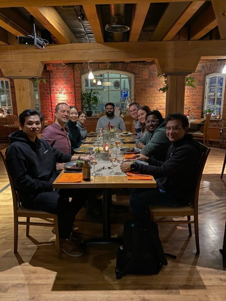 The team eating around a table.