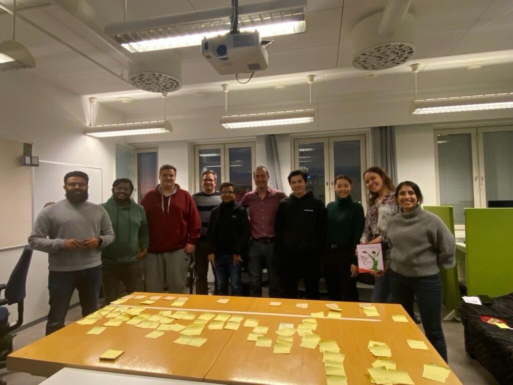 The team standing around a table.