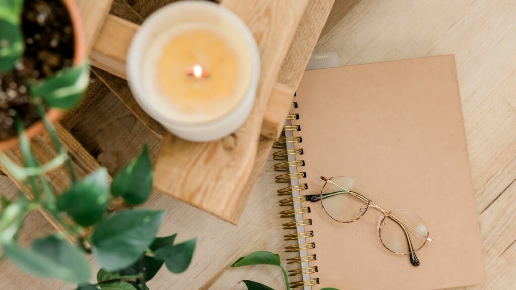 Glasses on top of beige notebook.