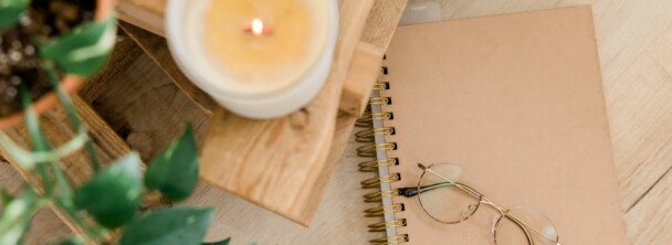 Glasses on top of beige notebook.